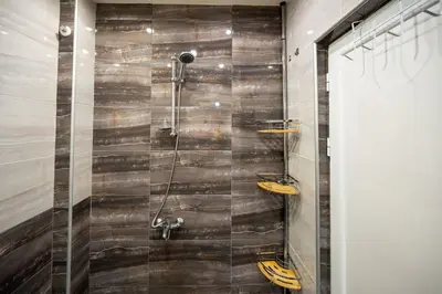 a bathroom with a shower with a glass door at Spacious 1BDR in the Center with FREE Parking in Sofia