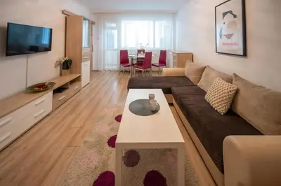 a living room with a couch and a table at Spacious 1BDR in the Center with FREE Parking in Sofia
