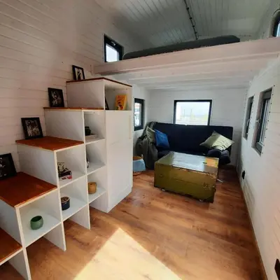 a living room of a tiny house with a couch at Bendji Land - vacation hideaway, close to Sofia in Ribarica