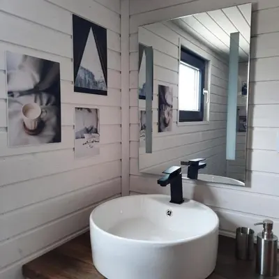a white bathroom with a sink and a mirror at Bendji Land - vacation hideaway, close to Sofia in Ribarica