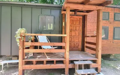 a cabin with a wooden deck and a door at Bendji Land - vacation hideaway, close to Sofia in Ribarica