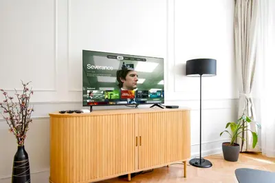 a tv sitting on top of a cabinet in a living room at Stylish 2BD with Balcony & Desk near Vitosha Blvd by Flat Mаnager in Sofia