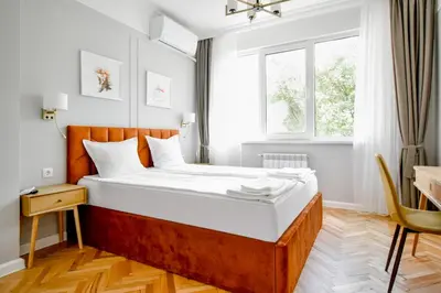 a large bed in a room with a window at Stylish 2BD with Balcony & Desk near Vitosha Blvd by Flat Mаnager in Sofia