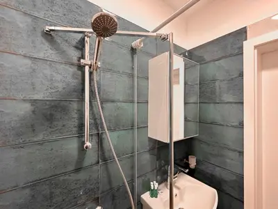 a bathroom with a shower and a toilet at Stylish 2BD with Balcony & Desk near Vitosha Blvd by Flat Mаnager in Sofia