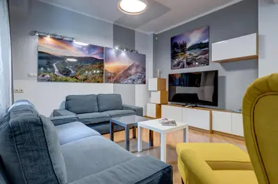 a living room with a couch and a tv at San Stefano 4 Free Parking 2 BRDM 100m Zaimov Park in Sofia