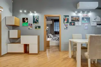 a living room with a table and a dining room at San Stefano 4 Free Parking 2 BRDM 100m Zaimov Park in Sofia
