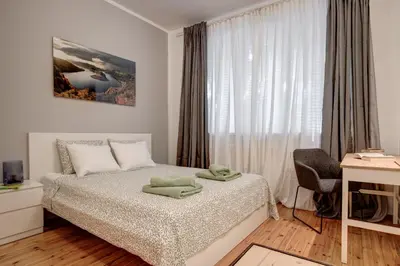 a bedroom with a bed and a desk and a window at San Stefano 4 Free Parking 2 BRDM 100m Zaimov Park in Sofia