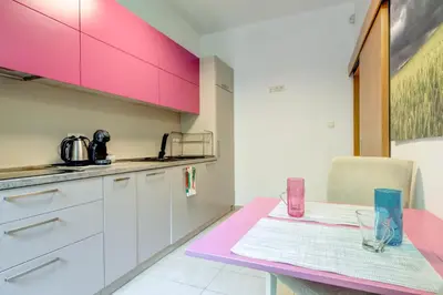 a kitchen with pink cabinets and a pink table at San Stefano 4 Free Parking 2 BRDM 100m Zaimov Park in Sofia