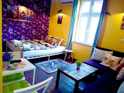 a living room with a bed and a table at Jazzy Art Home - Top Center - plus Free Vouchers in Sofia