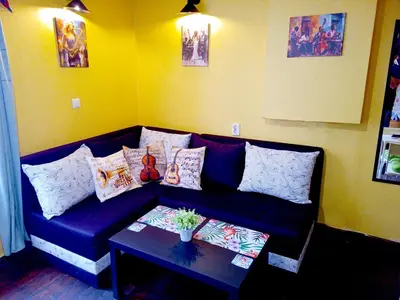a living room with a blue couch with pillows and a table at Jazzy Art Home - Top Center - plus Free Vouchers in Sofia
