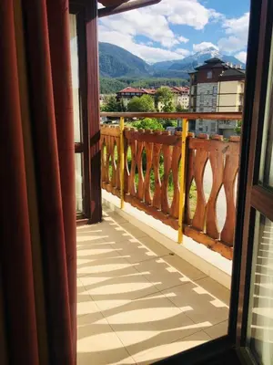 a balcony with a view of the mountains at Beautiful two bedroom 4th floor apartment in Elegant Luxe Hotel with pool, sauna, gym and steam room in Bansko