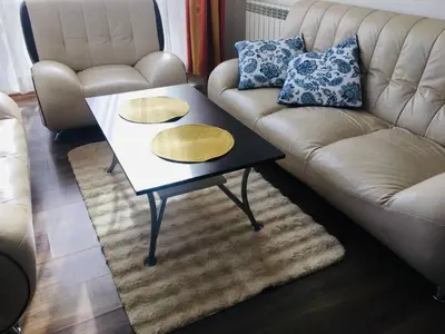 a living room with a couch and a coffee table at Beautiful two bedroom 4th floor apartment in Elegant Luxe Hotel with pool, sauna, gym and steam room in Bansko