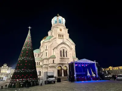 a christmas tree in front of a large building at Bright, City Centre, 1BR Apartment , Next to Sofia University in Sofia