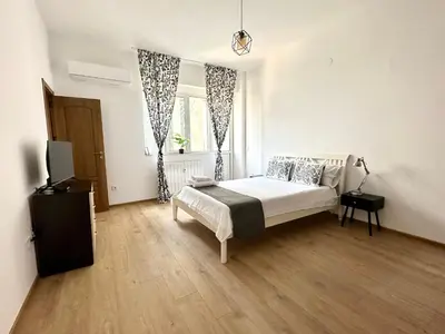 a bedroom with a bed and a television in it at Bright, City Centre, 1BR Apartment , Next to Sofia University in Sofia