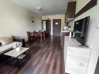 a living room with a couch and a table at Aspen Apartment A208 3OOm from Gondola in Bansko