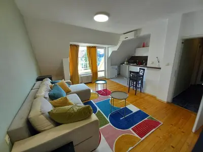 a living room with a couch and a table at the green apart in Sofia