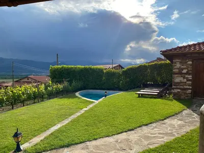 a backyard with a swimming pool and a bench at Къщата на тати in Garmen