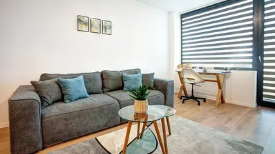 a living room with a couch and a table at College Flat - Wi-Fi with 600 Mbit speed in Sofia