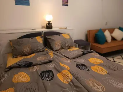 a bed with orange and black sheets and pillows at Apartament KETI улица Христо Максимов 56 вхВ in Sofia