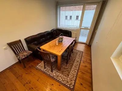 a living room with a table and a couch at Къща Добринище in Dobrinishte