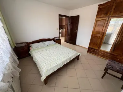 a bedroom with a bed and a dresser at Къща Добринище in Dobrinishte