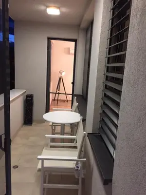 a table in a room with a camera on a tripod at Apartment Braila in Plovdiv