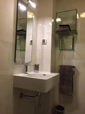 a bathroom with a white sink and a mirror at Apartment Braila in Plovdiv