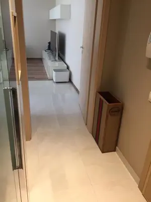 a room with a television and a white floor at Apartment Braila in Plovdiv