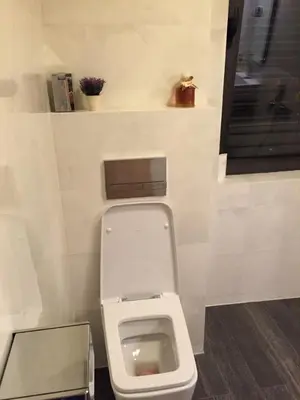 a bathroom with a white toilet in a room at Apartment Braila in Plovdiv