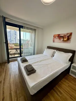 a large bed in a room with a large window at D&G City Homes in Sofia