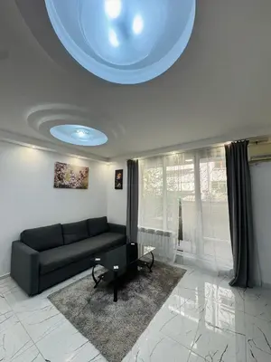 a living room with a couch and a table at Top Central Apartment 2 in Sofia