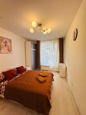 a bedroom with a large bed and a window at Top Central Apartment 2 in Sofia