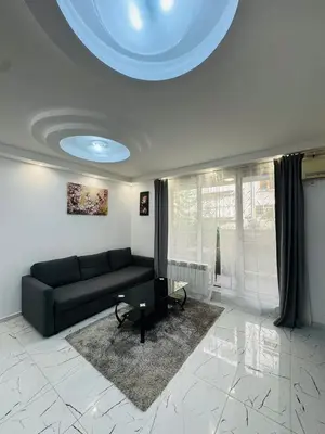 a living room with a couch and a table at Top Central Apartment 2 in Sofia