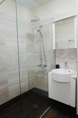 a white bathroom with a sink and a shower at Top Central Apartment 2 in Sofia