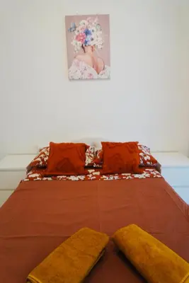 a bed with two pillows and two towels on it at Top Central Apartment 2 in Sofia