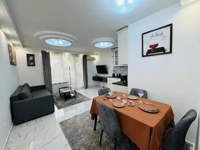 a dining room with a table and a living room at Top Central Apartment 2 in Sofia