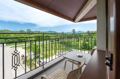 a balcony with a table and chairs and a view at Hotel Royal Bath in Banya