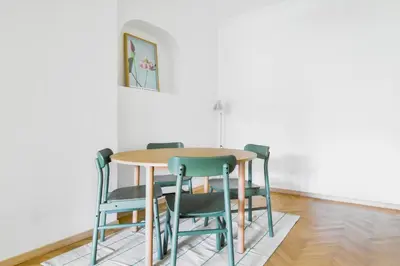 a dining room table with chairs and a picture on the wall at Scandinavian Charm - Central 1BD with Desk by Flat Manager in Sofia