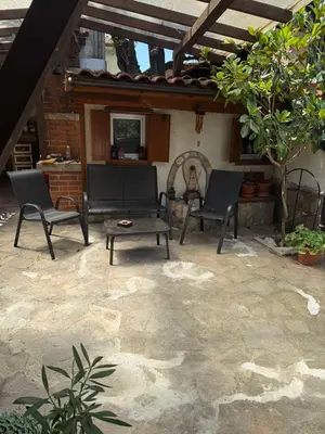 two chairs and a table on a patio at Къща за гости Гаджо Gadjo in Bansko