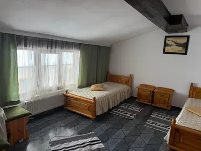 a bedroom with a bed and a window at Къща за гости Гаджо Gadjo in Bansko