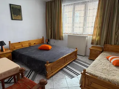 a bedroom with two beds and a window at Къща за гости Гаджо Gadjo in Bansko