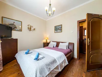 a bedroom with two beds and a flat screen tv at Aristocratic Top Central Apartment in Sofia