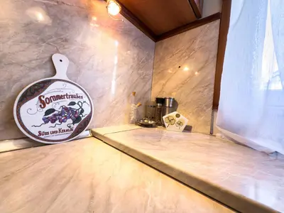 a room with a counter with a sign on the wall at Aristocratic Top Central Apartment in Sofia