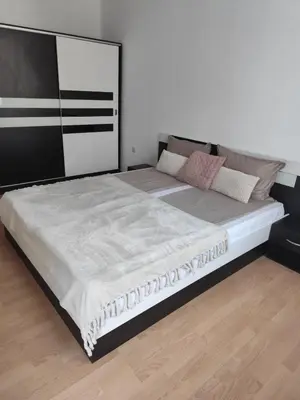 a bedroom with a large bed in a room at Guest House Amaya Riva in Plovdiv