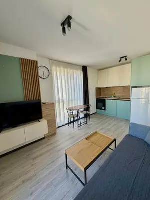 a living room with a couch and a table at Stay Point One Bedroom Apartment Including Underground Parking Place in Sofia