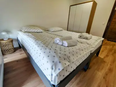 a bed with pillows and a mirror in a bedroom at White Peak 2rooms ap in Bansko
