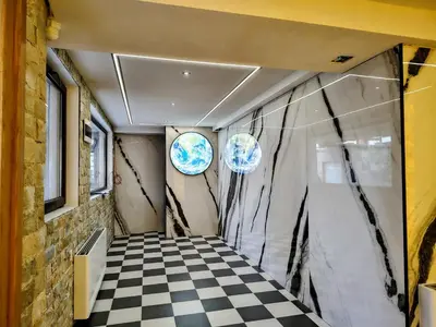 a room with a checkered floor and two windows at White Peak 2rooms ap in Bansko