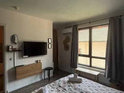a bedroom with a bed and a flat screen tv at Luxury Studio2 in Hotel Friends in Bansko