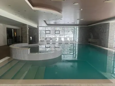 a swimming pool in a building with a swimming pool at Chamkoria Forest View & Spa Apartment in Borovets