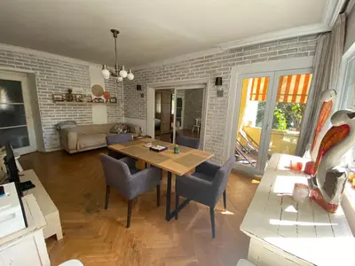 a living room with a wooden table and chairs at Journalist squad in Sofia